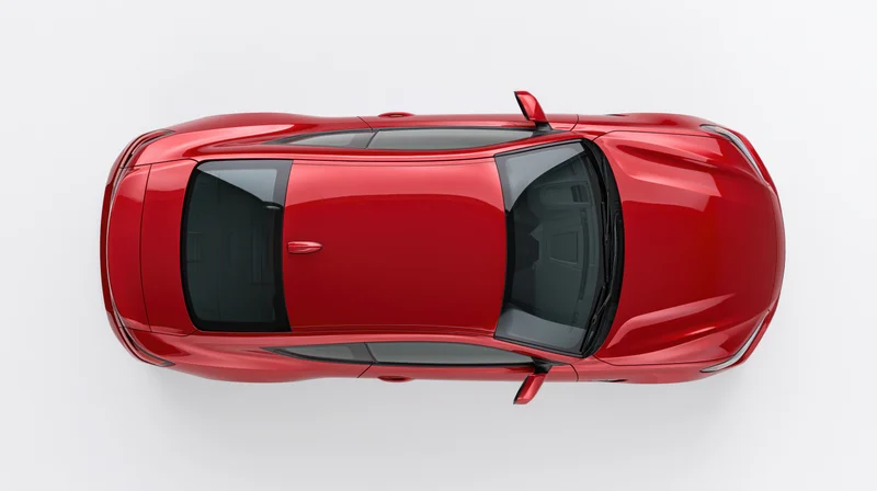Red sporty coupe sedan viewed from directly overhead against white background