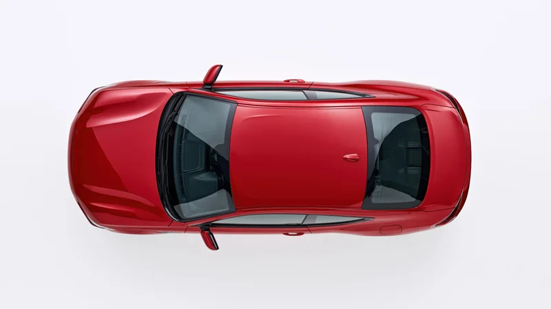 Red sporty coupe sedan viewed from directly overhead against white background