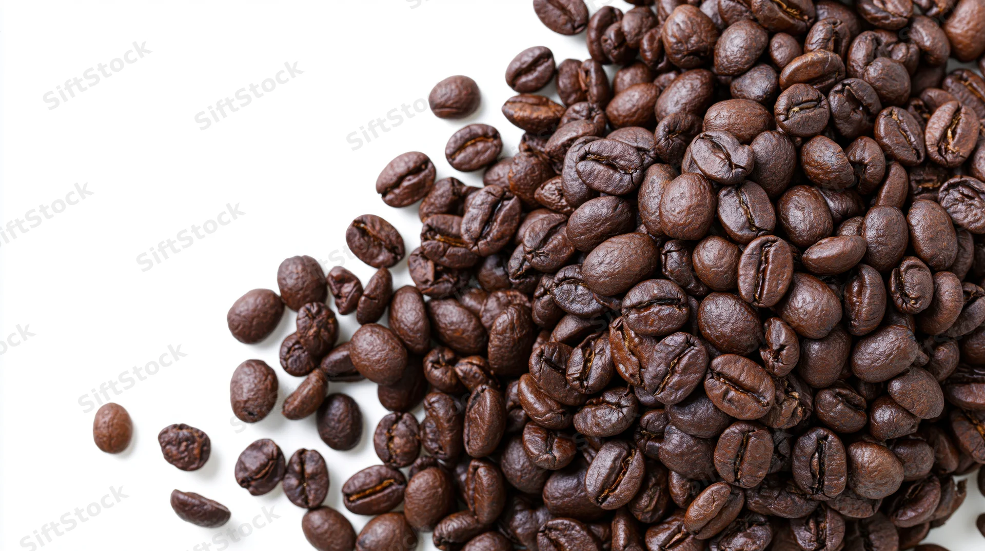 Roasted coffee beans scattered and falling midair in a cluster on white background