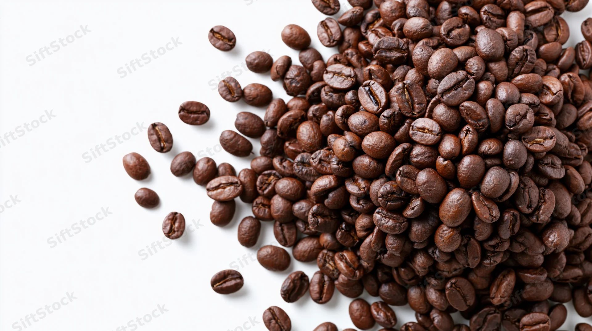 Roasted coffee beans scattered and falling midair in a cluster on white background