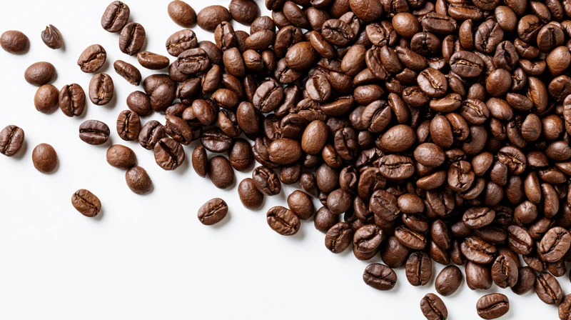 Roasted coffee beans scattered and falling midair on white background