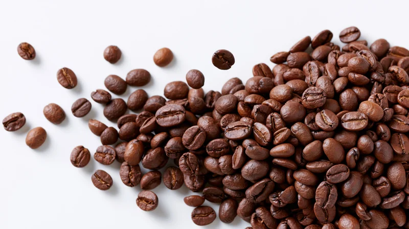 Roasted coffee beans scattered and falling mid-air clustered