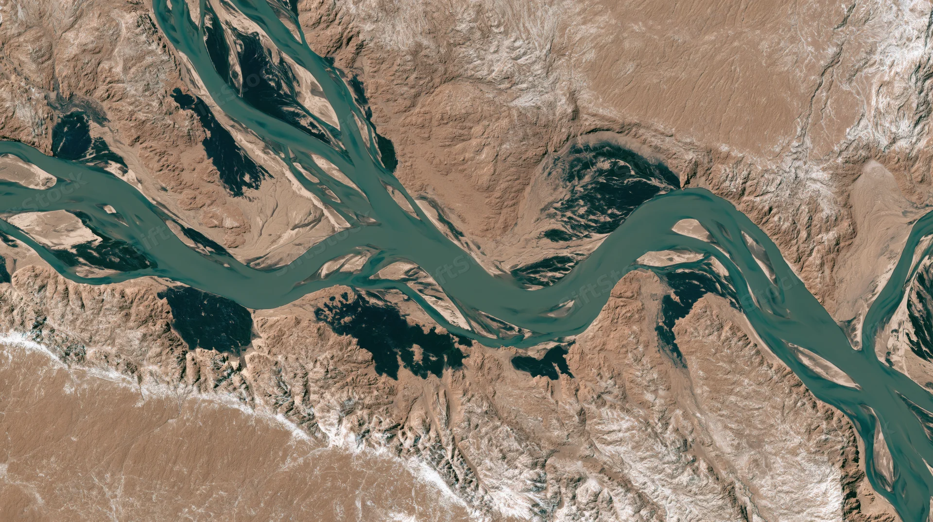 Satellite view of a river delta winding through arid terrain