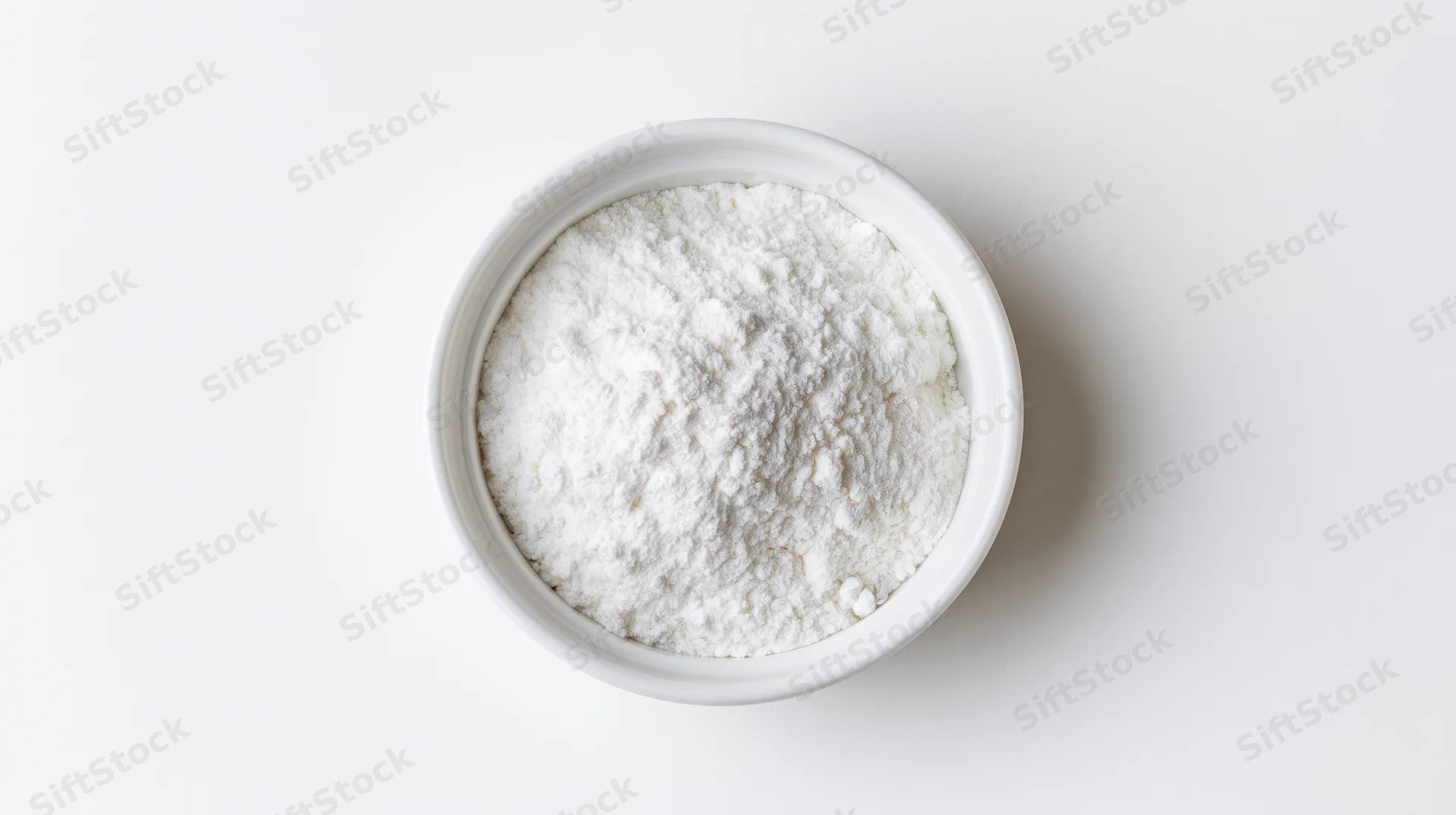 White powder in a small ceramic bowl on a plain white surface