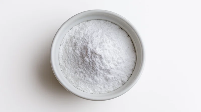 White powder in a ceramic bowl on a plain white surface