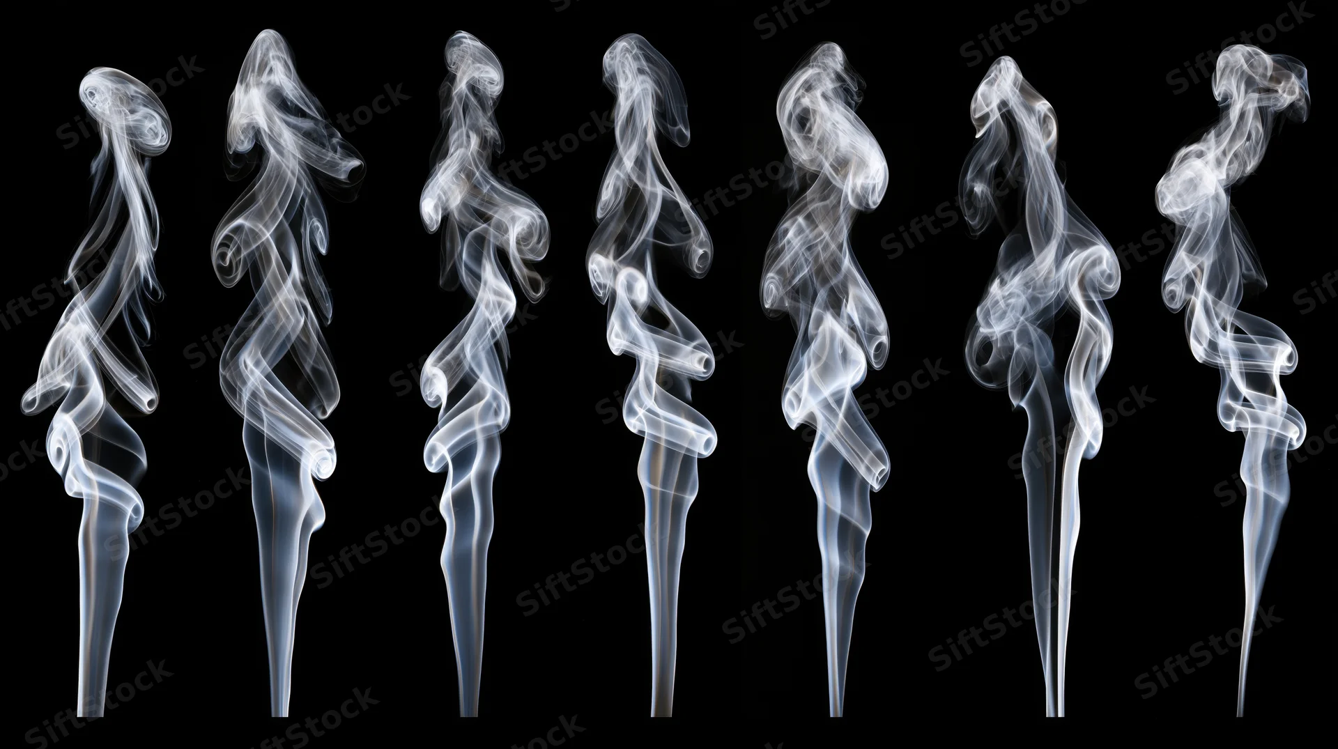 White smoke wisps rising and curling in a row against black background