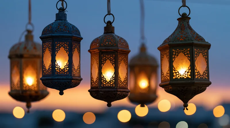 Ornate arabic lanterns hanging and glowing against twilight sky with bokeh lights in background
