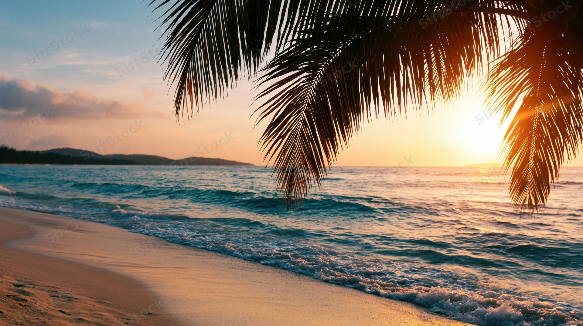 Golden hour sunset over tropical beach with palm fronds framing turquoise waves washing onto sand