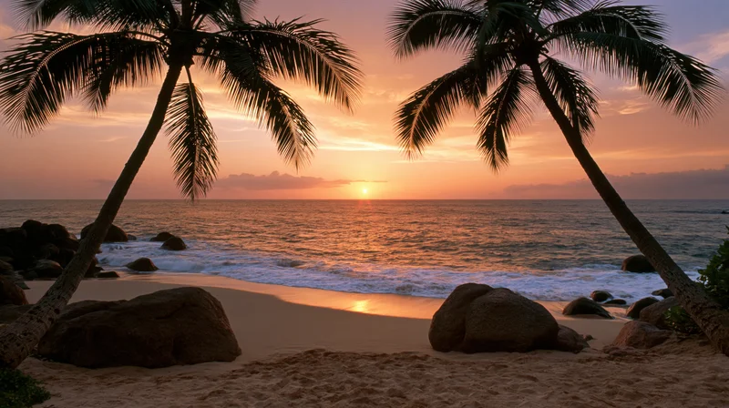Tropical beach at sunset framed by two leaning coconut palms