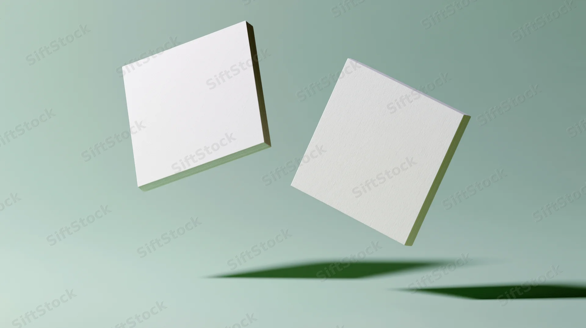 Two blank white square cards floating at slight angles against a light green background with soft shadows