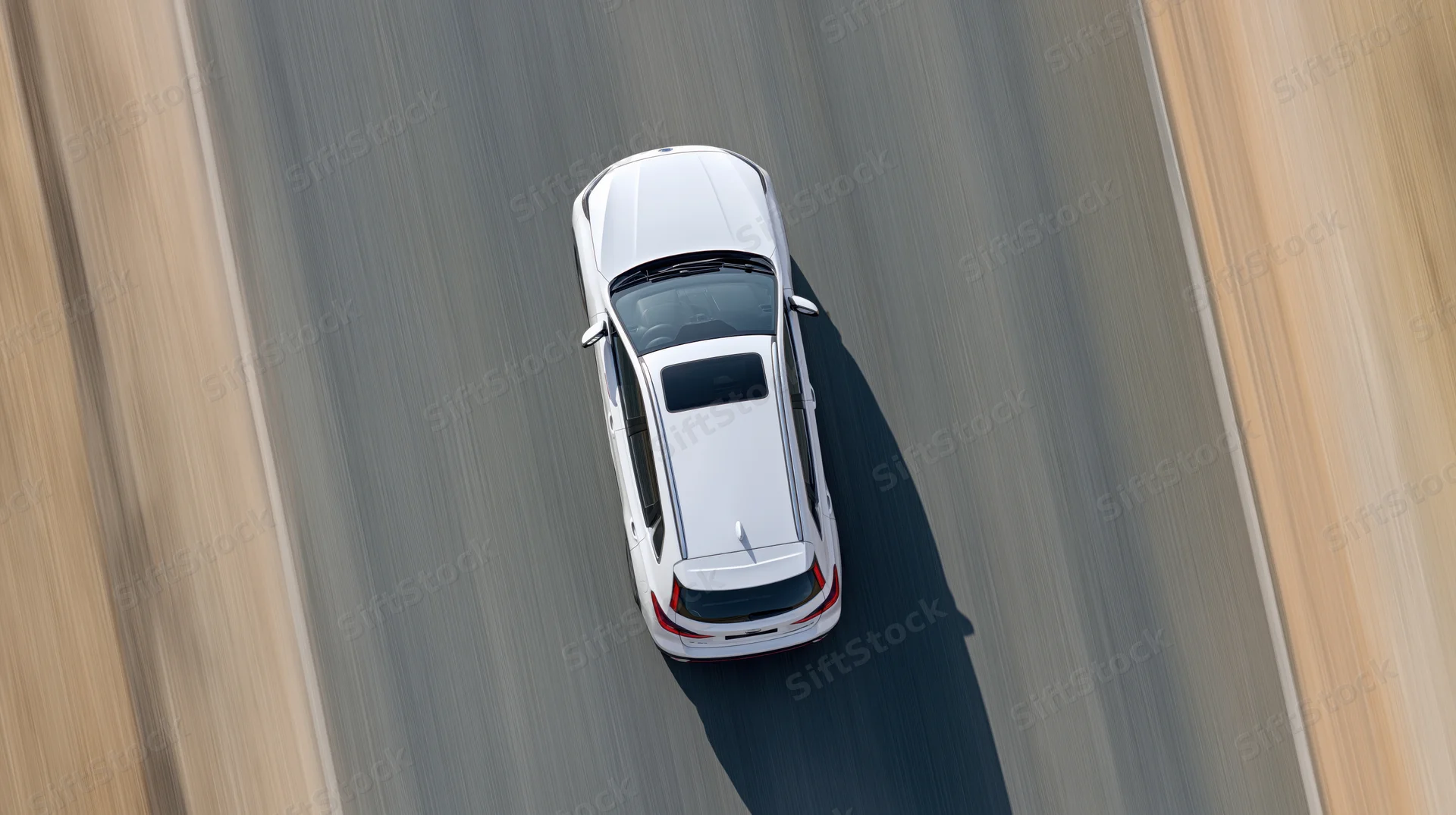 White suv driving at speed on highway viewed from directly above