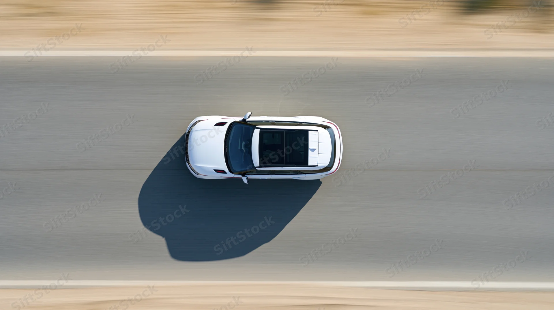 White suv driving at speed on highway viewed from directly above