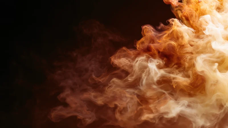 Swirling amber and cream smoke dispersing against dark background