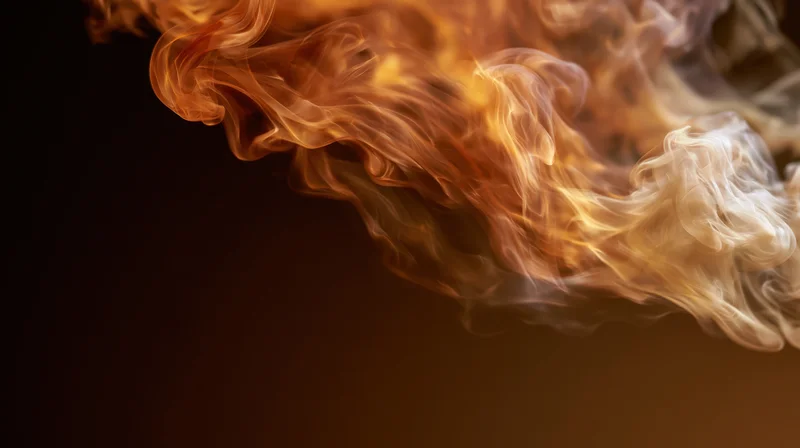 Swirling wisps of amber and cream smoke dispersing against a dark background