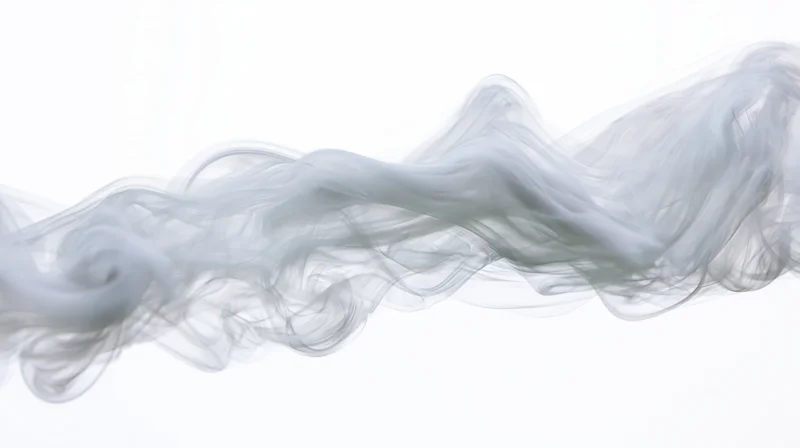 Wispy smoke drifting horizontally across a pure white background