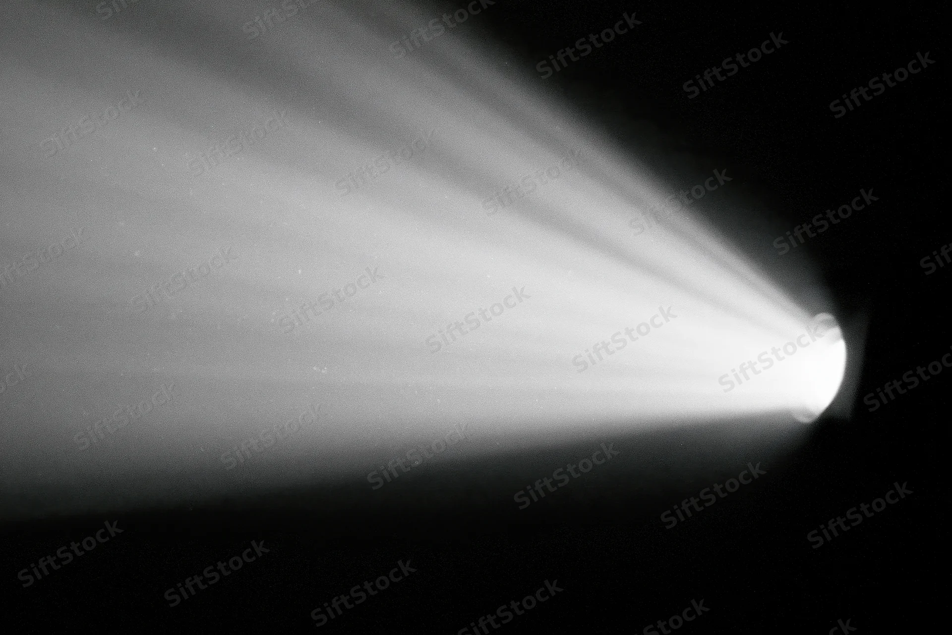 Cinema projector beam cutting through dark room