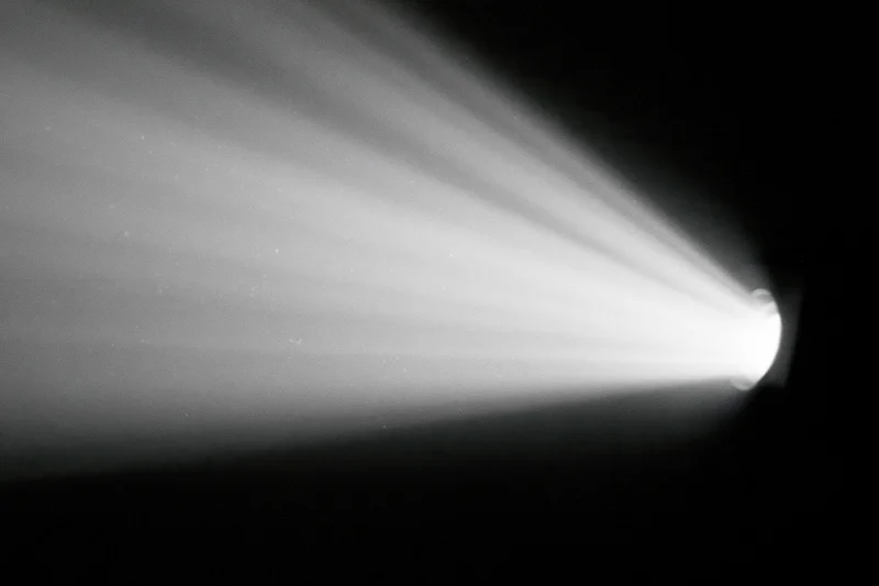 Cinema projector beam cutting through dark room