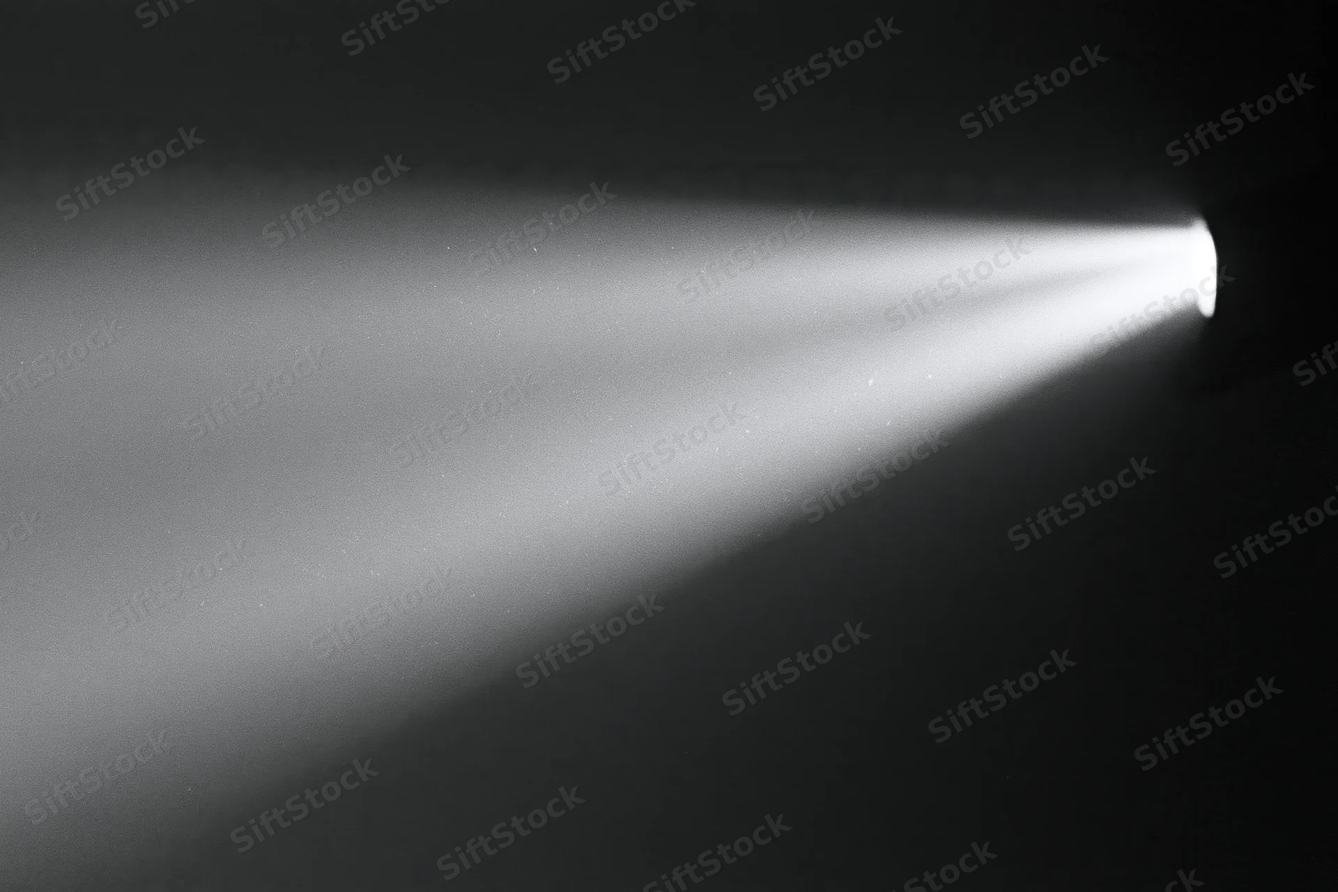 Projector beam cutting through dark room in cinema setting