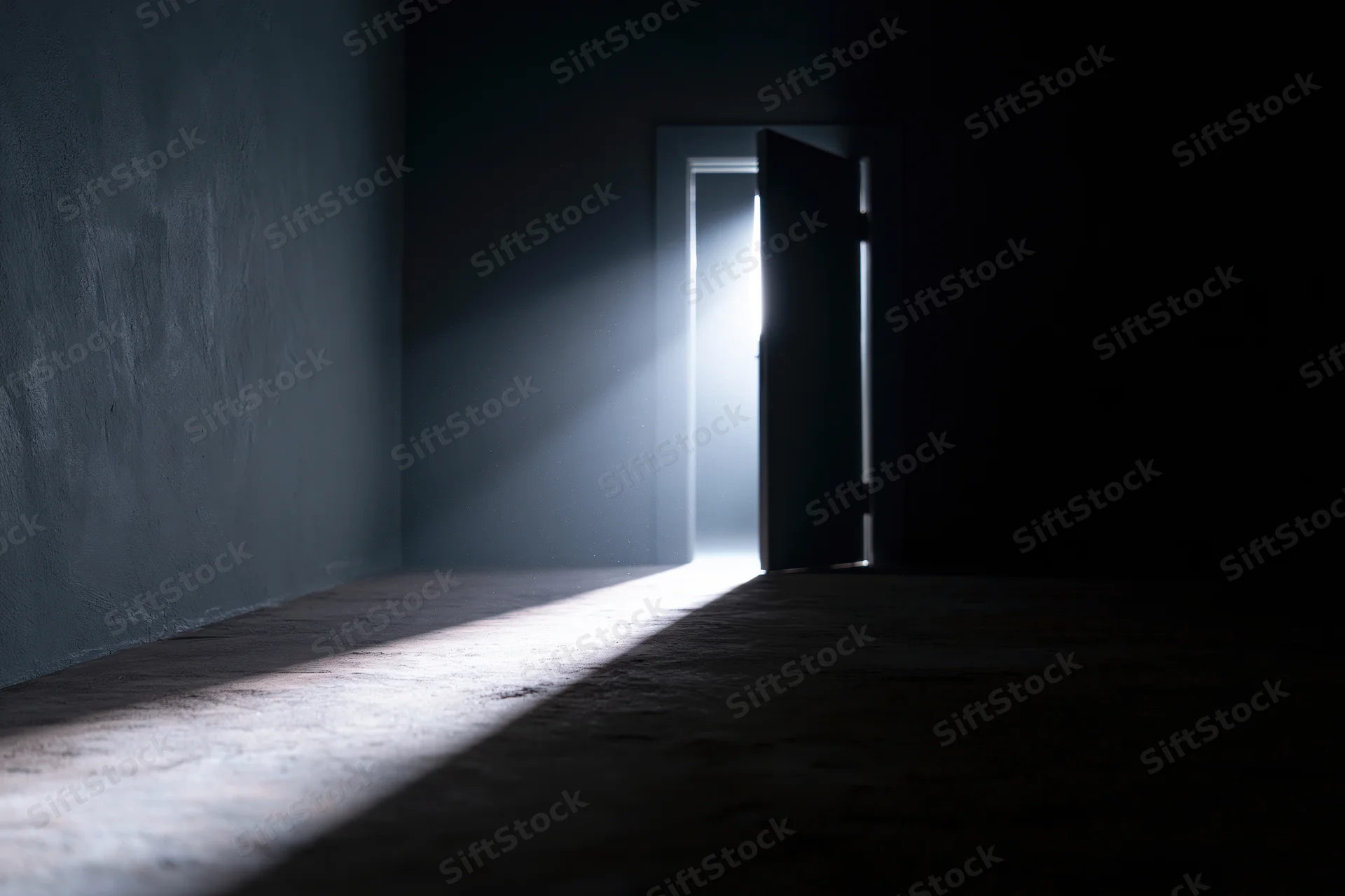 Slightly open door in dark room letting in bright light