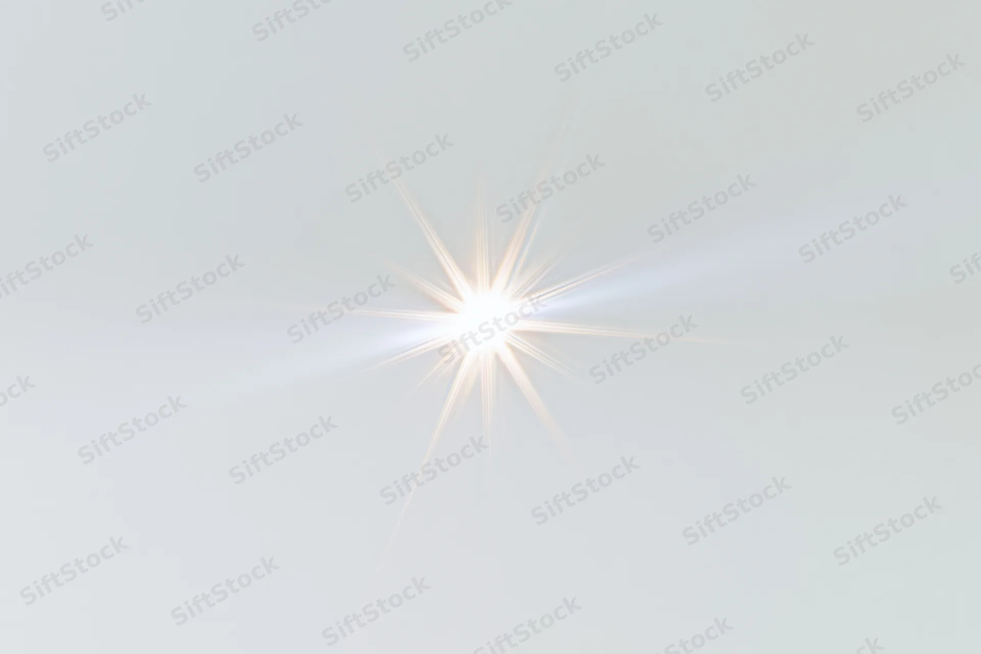 Bright lens flare starburst centered on a pure white background