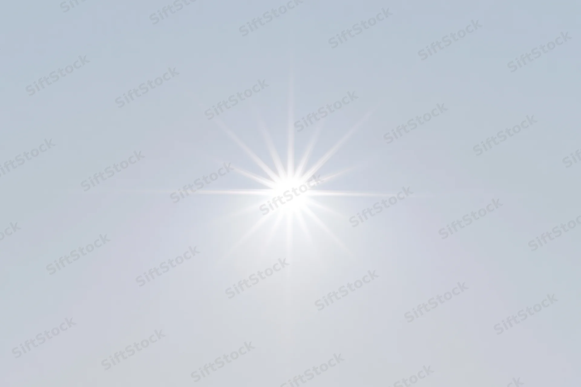 Bright lens flare starburst centered on a pure white background