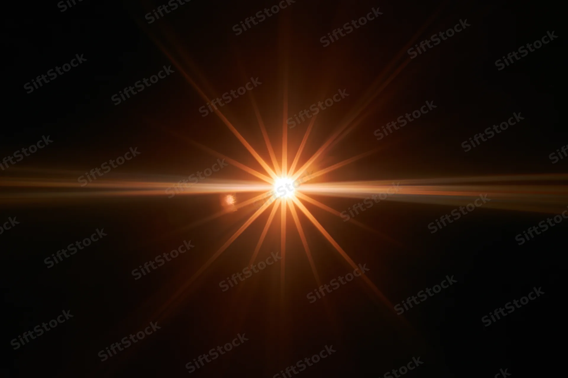Bright point of light bursting with starburst flare against black background