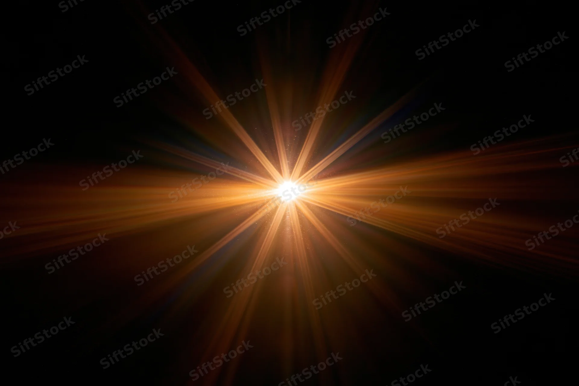 Bright point of light emitting radial lens flare against dark background