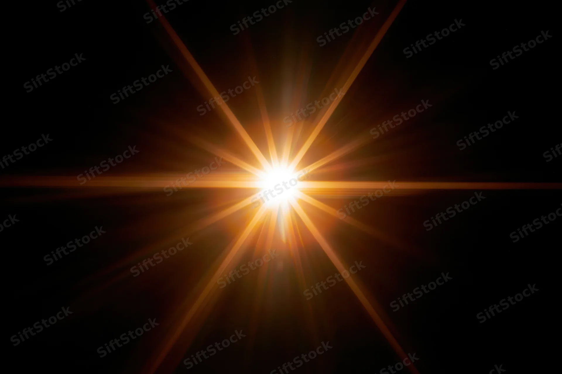 Bright point of light emitting radial lens flare against black background