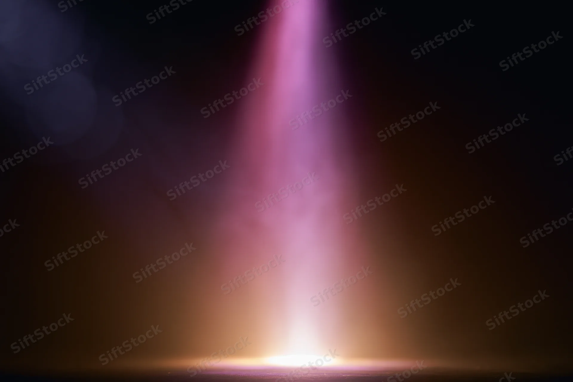 Vertical beam of light rising from a bright point in dark space with purple and orange glow