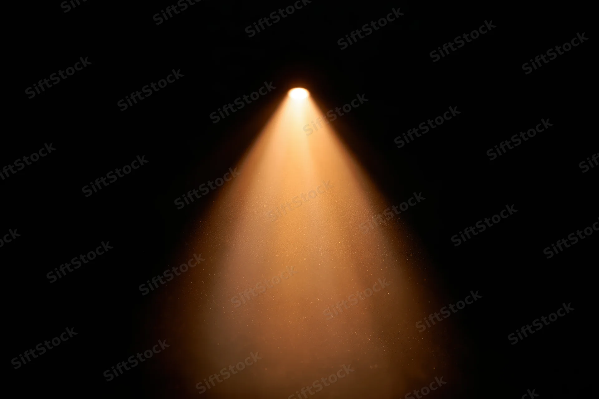 Warm amber spotlight beam cutting downward through dark space