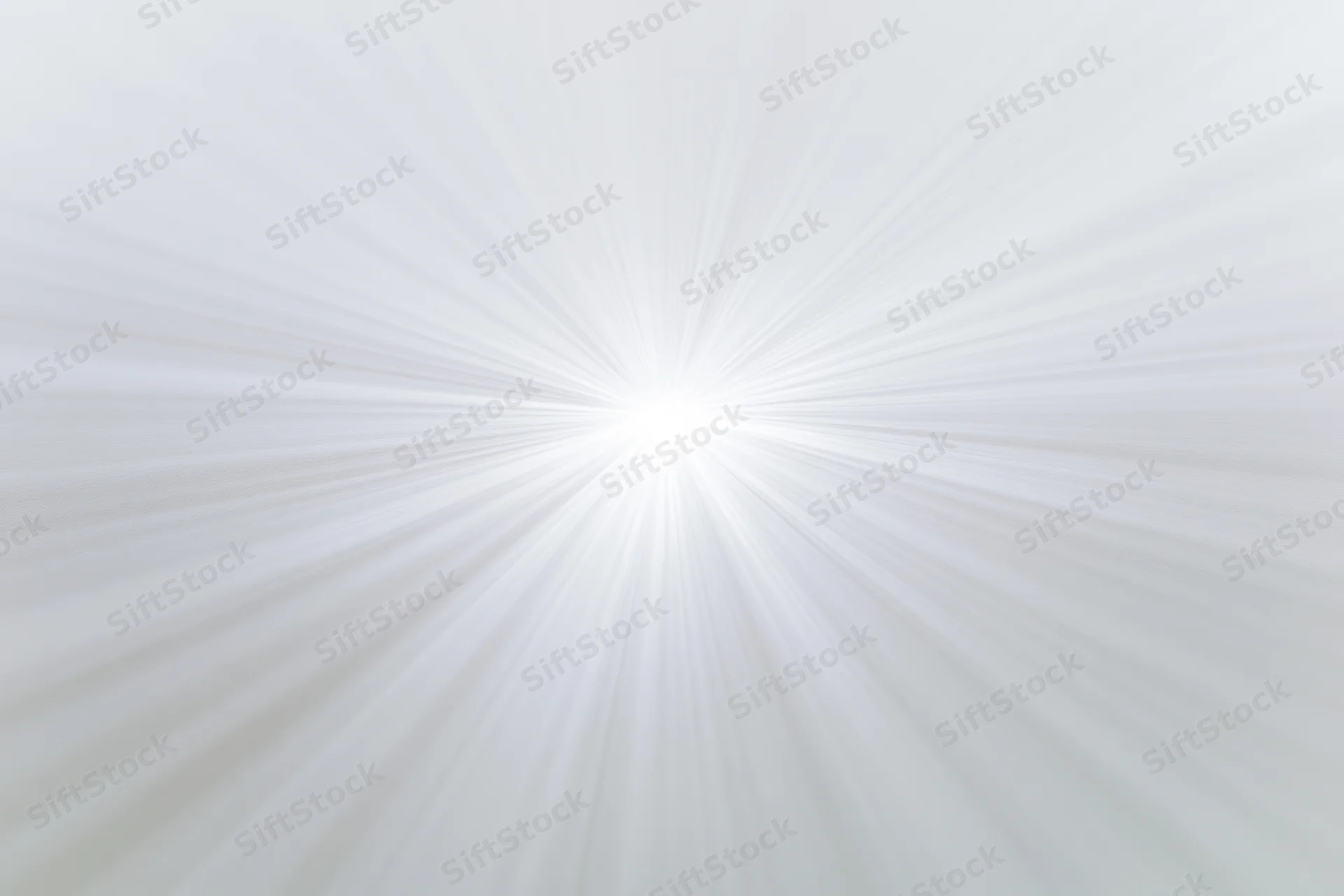 Soft radial burst of light rays emanating from a bright center against a white background
