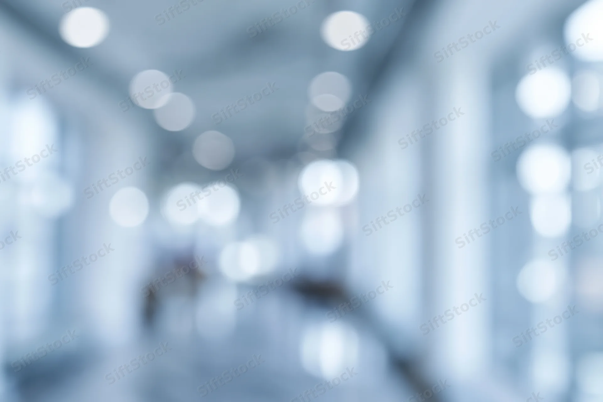 Blurred interior hallway with soft bokeh lights along the ceiling and walls