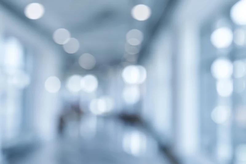 Blurred interior hallway with soft bokeh lights along the ceiling and walls