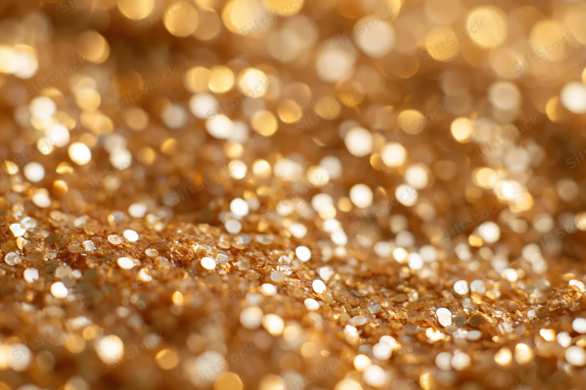 Densely packed gold glitter creating a sparkling bokeh effect across the frame