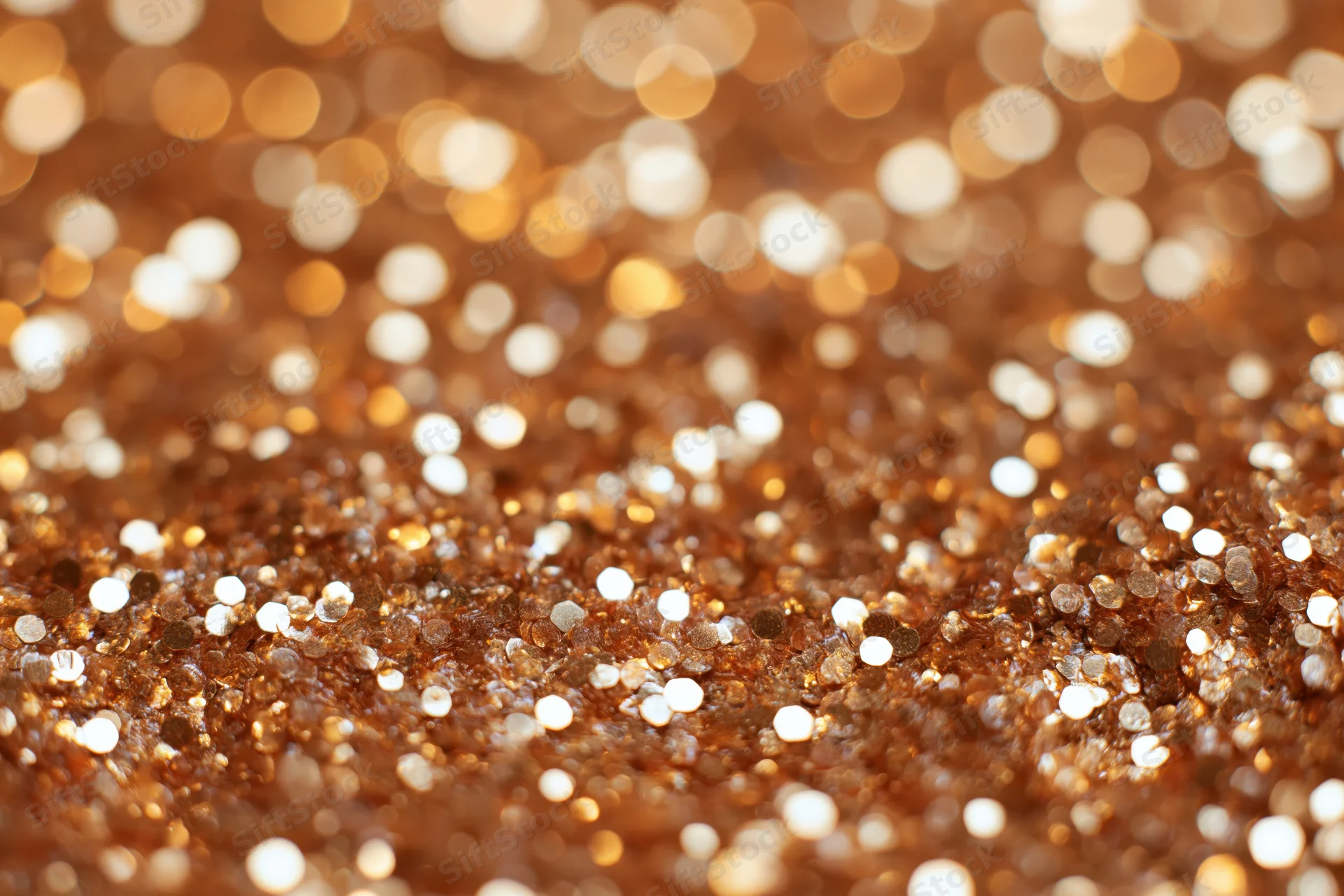 Densely packed glitter creating a sparkling bokeh effect with warm golden and brown tones
