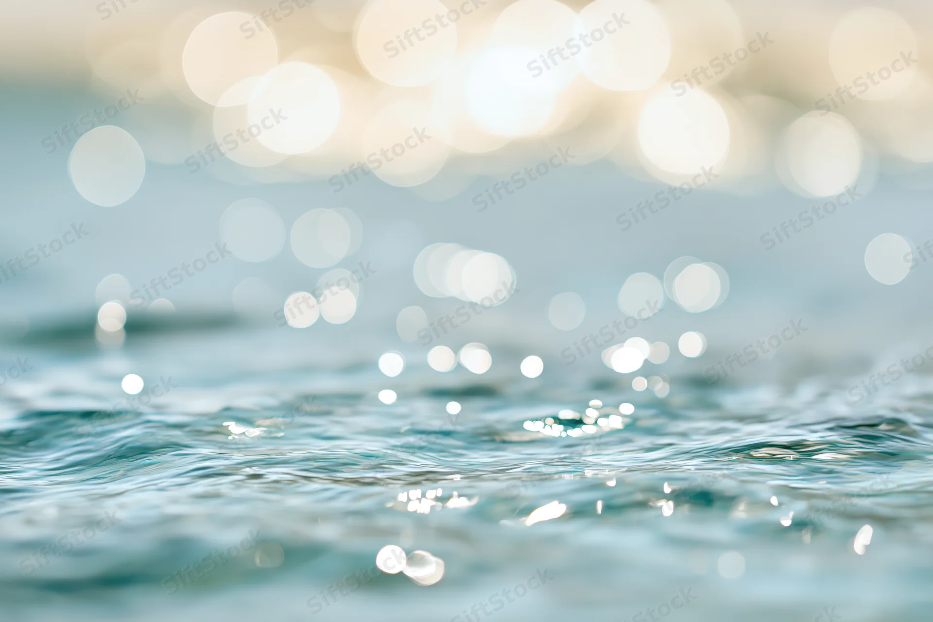 Abstract bokeh background of sunlit ocean water surface bright