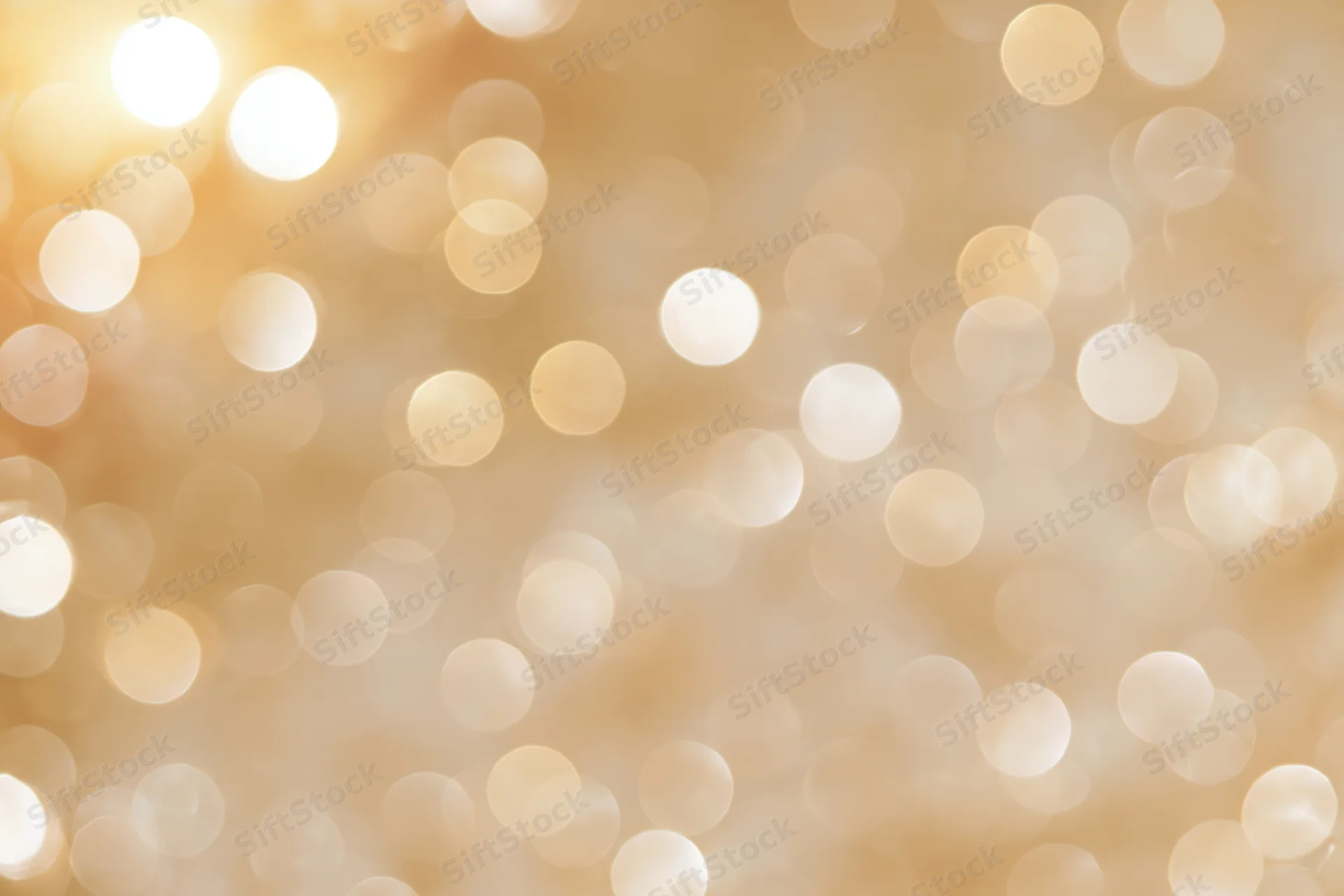 Soft out-of-focus golden light orbs forming a warm abstract background