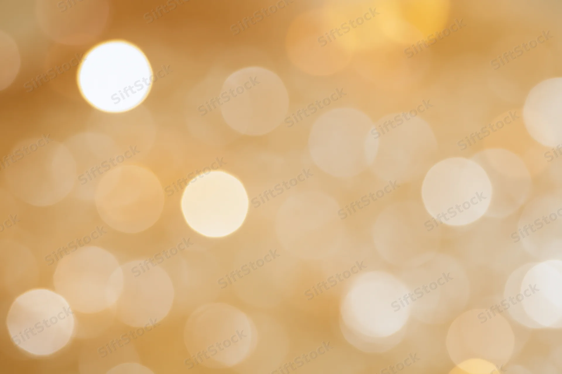 Soft out-of-focus golden light orbs forming a warm abstract background