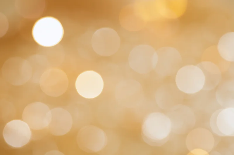 Soft out-of-focus golden light orbs forming a warm abstract background