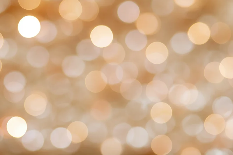Soft out-of-focus golden light orbs forming a warm abstract background