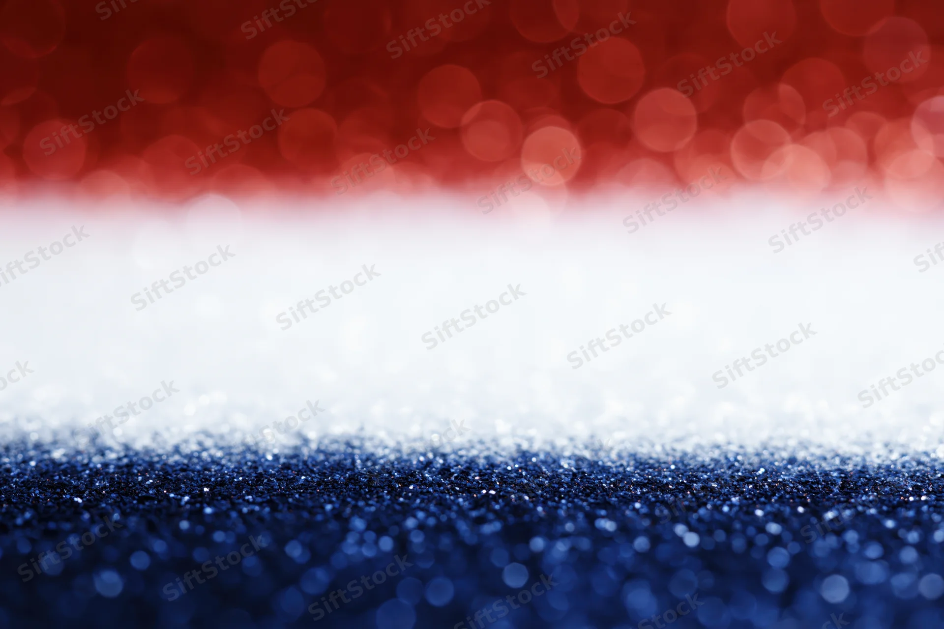 Abstract bokeh background with red white and blue light circles fading into soft focus