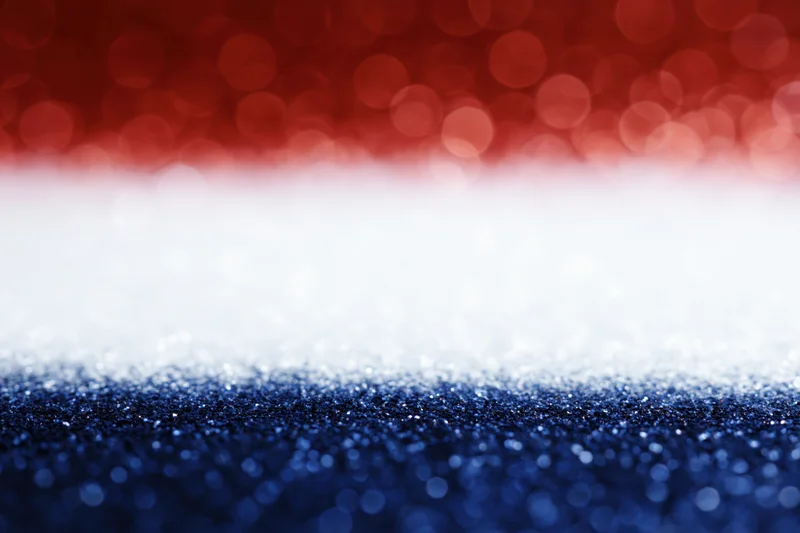 Abstract bokeh background with red white and blue light circles fading into soft focus