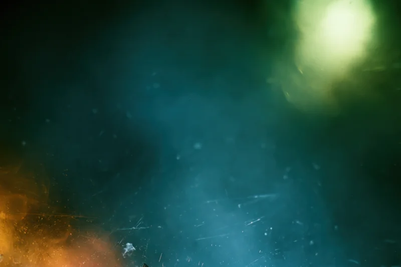Abstract close-up of a dusty scratched glass surface with soft light and haze
