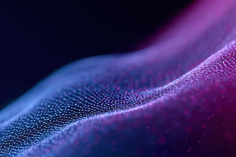 Glowing dot-grid mesh forming a flowing digital wave with purple and blue gradient lighting