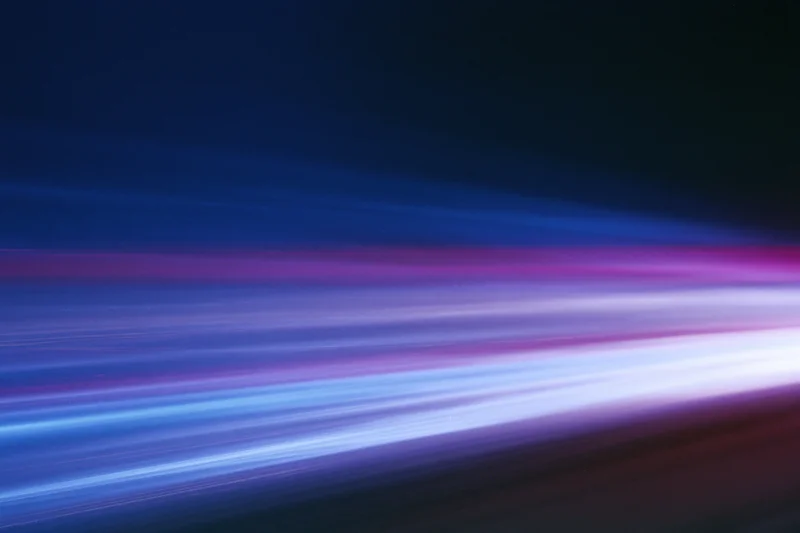 Horizontal light streaks from moving vehicles captured in long-exposure blur at night