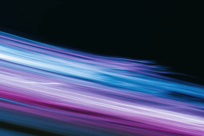 Abstract light streaks in motion blur against dark background