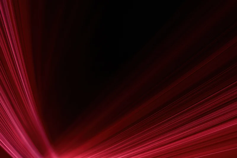 Red light streaks moving diagonally across dark background