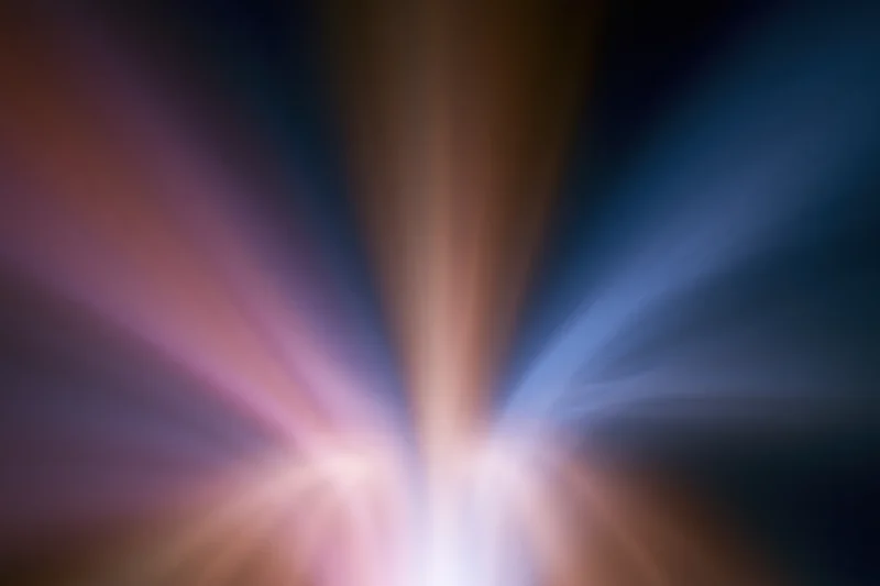 Vertical light streaks radiating upward from a central point in an abstract long-exposure image