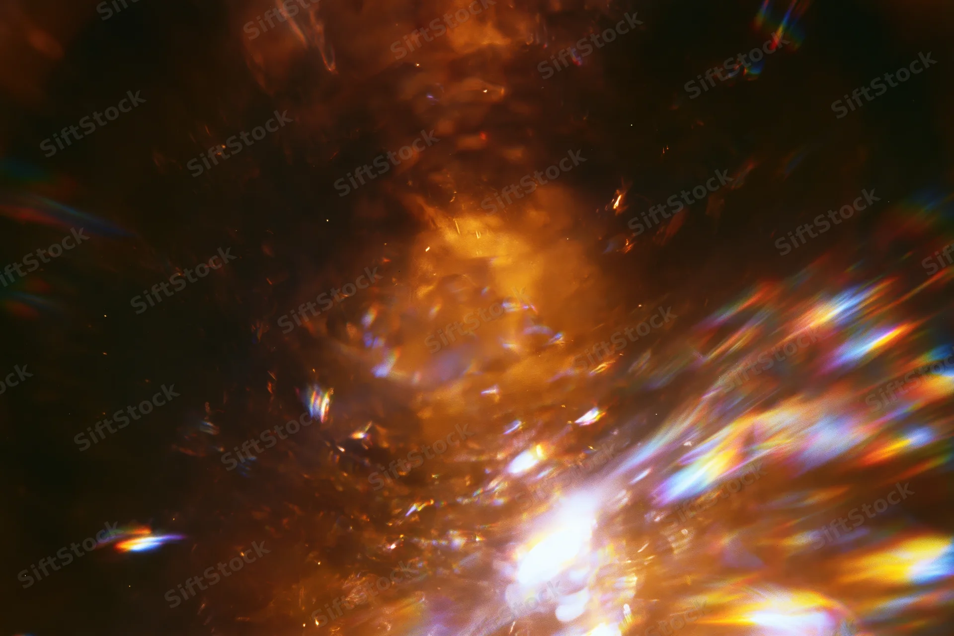Abstract light burst with lens flare streaks in low-light motion-blurred scene