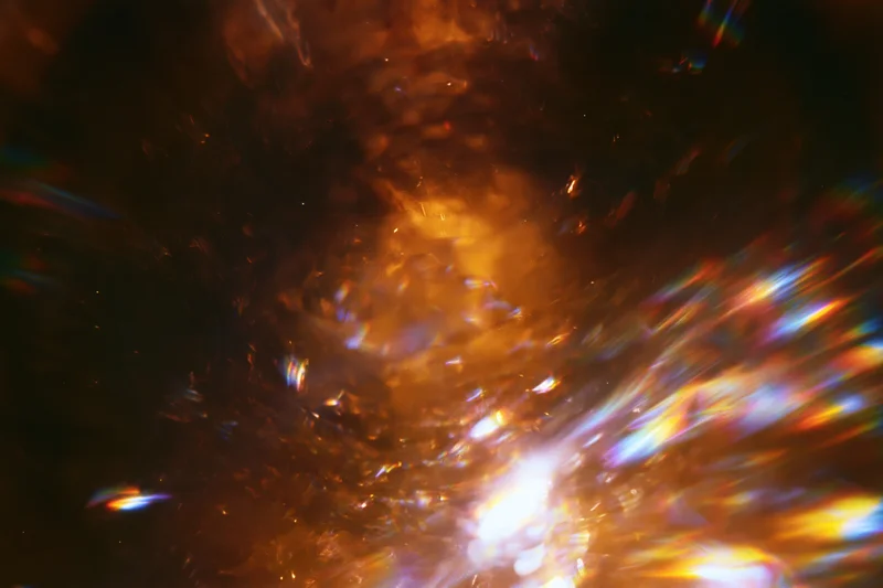Abstract light burst with lens flare streaks in low-light motion-blurred scene